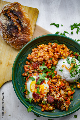 Cuadro en lienzo Mexican-style bowl with black beans, spicy chorizo sausage, roasted vegetables, fresh herbs, and rice
