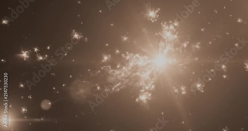 Abstract golden light bursts and trails in dark space.
