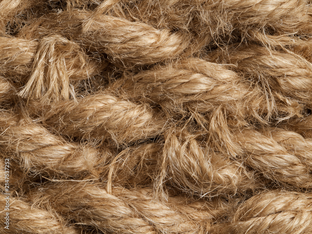 Fototapeta premium Close up of thick, coarse, natural fiber rope, showing the intricate weave and textured strands AI generative