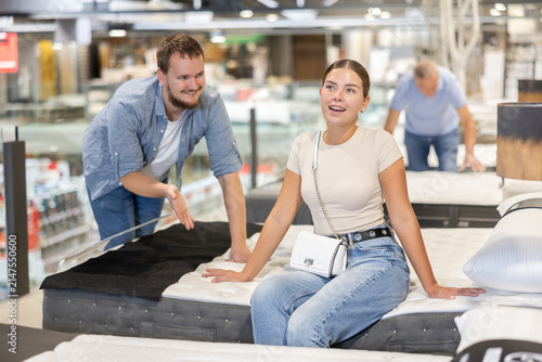 Принти на полотні In furniture store, spouses examines bed and mattress