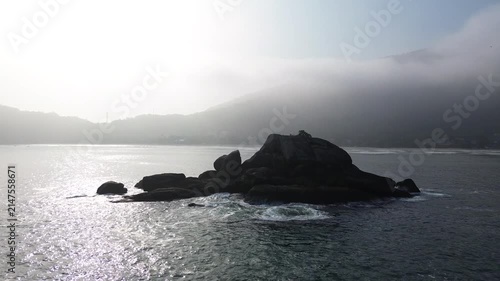 A dark island in the middle of the sea. An inhospitable atmosphere.