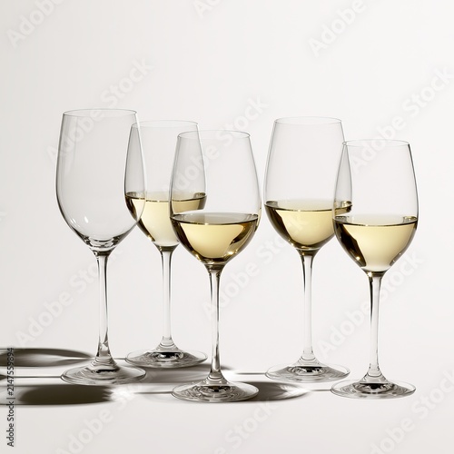 Wine glasses sit together on white backgrounds.