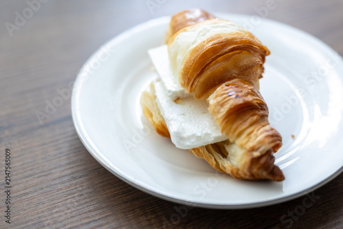 Canvastavla Close-up of fresh cheese croissant served on white plate