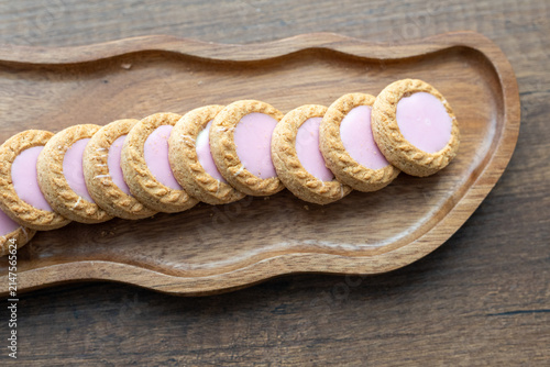 Close-up of cream sandwich biscuit on wooden serving board
