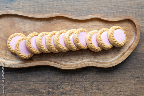 Close-up of cream sandwich biscuit on wooden serving board