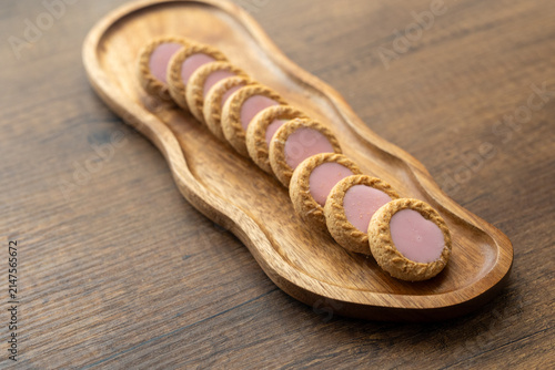 Close-up of cream sandwich biscuit on wooden serving board