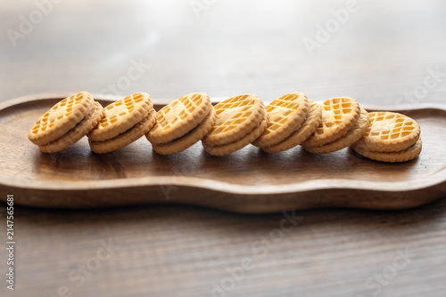 Close-up of cream sandwich biscuit on wooden serving board