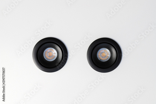 Konstfotografi Black recessed ceiling spotlights on white