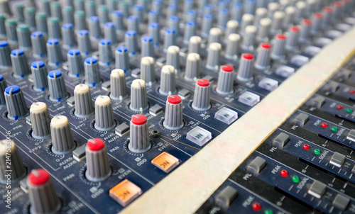 Audio mixing console knobs close-up, professional sound equipment