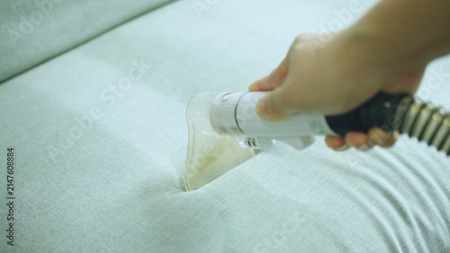 Close up Process of deep furniture cleaning, removing dirt from sofa. Washing concept.