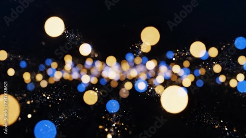 Abstract blue and gold bokeh lights on black background