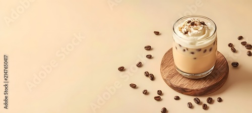 Iced coffee with cream in glass, elegant layered presentation, sophisticated coffee drink.

