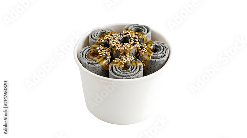 Elegant black sesame Thai rolled ice cream drizzled with golden honey and toasted seeds, isolated on white background