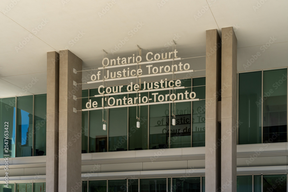 Fototapeta premium Toronto, Canada - August 5, 2026: The entrance to the Ontario Court of Justice building located on Armoury Street in Toronto, Canada. The Ontario Court of Justice is the provincial court of record.