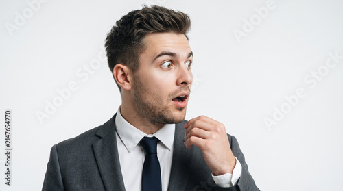 Photo, close-up, a man with a surprised expression looking to the side, with a background of announcements and product advertisements, 