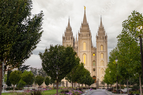 The Salt Lake Temple stands majestically in Temple Square in Salt Lake City, Utah, showcasing stunning Gothic and Romanesque architectural details. Its granite spires rise against a clear blue sky, su