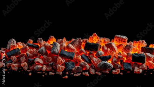 Glowing hot charcoal embers on a black background