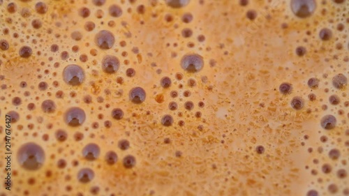 Macro video of hot frothy milk tea chai surface showing bubbling tea foam 180fps Captured in Cinematic High Detail Footage