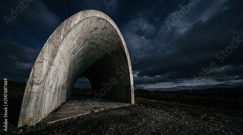 Dramatic night storm clouds looming over an ancient European stone city architecture and medieval historic bridge