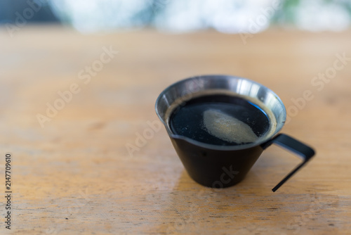 A close up shot of hot espresso on wood table