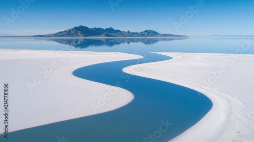 Winding River Through Salt Flats After Rainfall Under Clear Sky