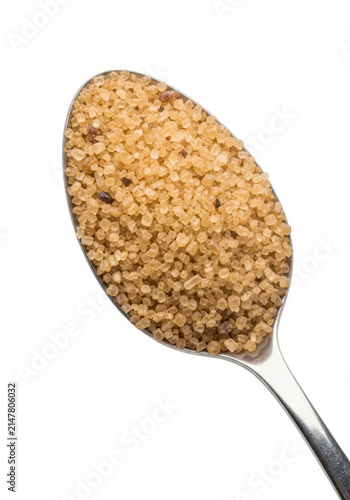 A metal spoon filled with raw brown cane sugar granules for baking and sweetening food drinks isolated on transparent background