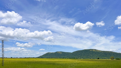 фотографія A breathtaking natural landscape showcasing a bright blue sky with soft white cl