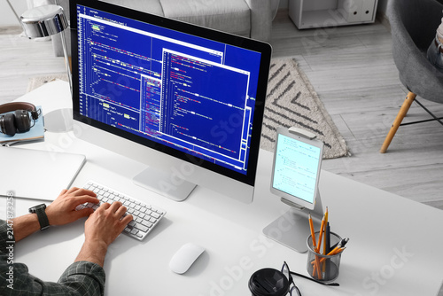 Programmer coding on a desk...