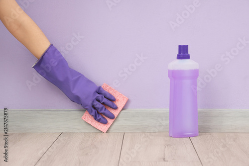 Female hand cleaning basebo...