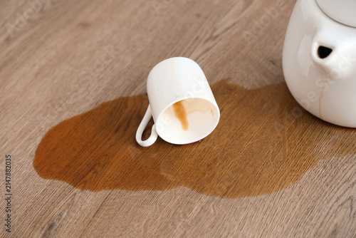 Canvastavla Overturned cup, pot and spilled coffee on table in kitchen