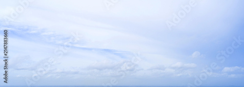 Photography Wide panoramic view of bright light blue sky with soft white wispy clouds, natural clear daytime atmosphere texture backdrop for website header banner and background
