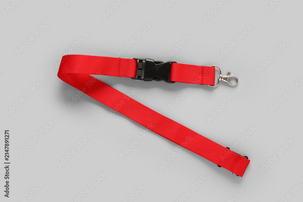 Obraz premium Red lanyard for badge on grey background