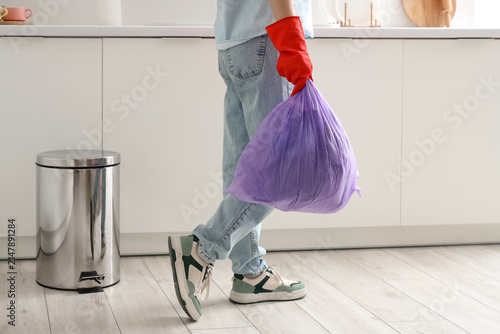 Woman with garbage bag in kitchen