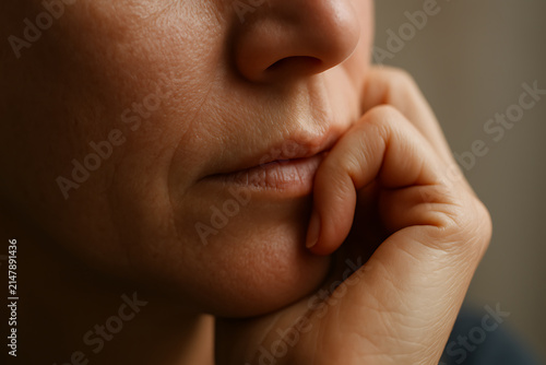 Close up of a thoughtful person resting chin on hand in quiet reflection