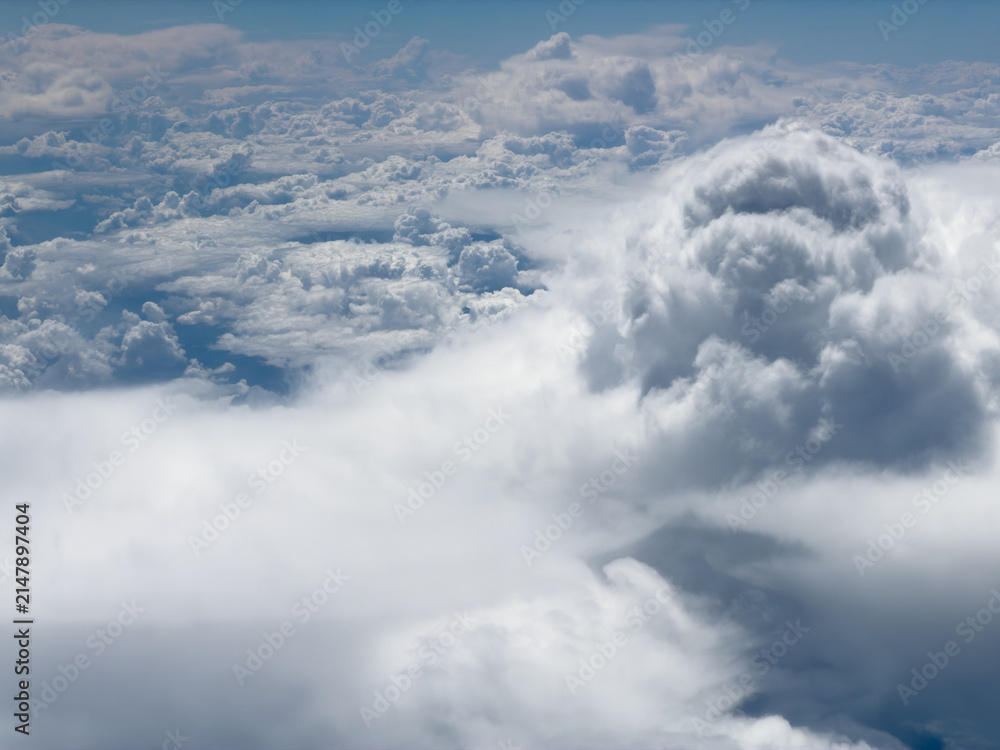 Fototapeta premium High-altitude view of clouds from airplane window