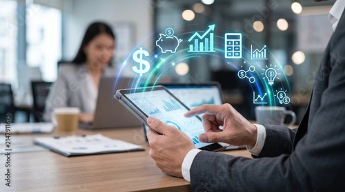 Digital finance and accounting featuring hands holding tablet with floating holographic icons representing money, piggy bank, calculator, graphs and lightbulb ideas for financial