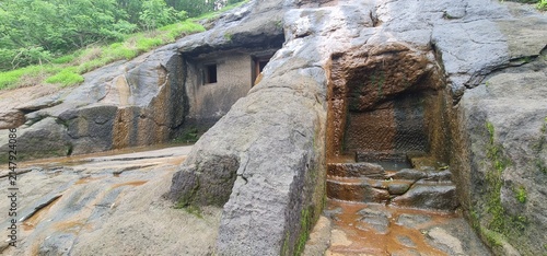 Exterior View of Ancient Rock Cut Facade and Wet Basalt Walls of Kuda Caves in Monsoon, Maharashtra