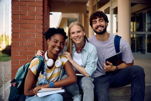 Portrait of happy college students at campus looking at camera.
