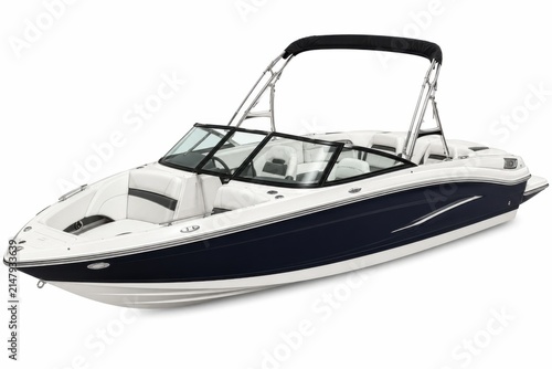 Luxury speedboat cruising on open water. High-performance white and blue motorboat with sun canopy for leisure boating.