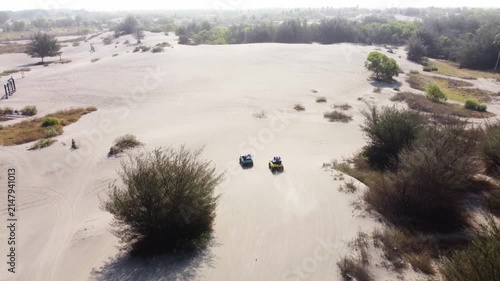 Aerial View of Two Off Road Vehicles Crossing Gumuk Pasir Parangkusumo Sand Dunes, Yogyakarta, Indonesia