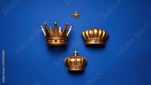 Golden royal crowns collection on blue background, set of three majestic gold crown symbols, luxury monarch headwear with star icon