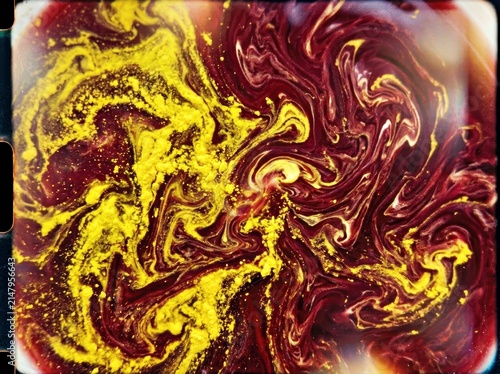 Swirling Oil and Mustard on a Dark Surface