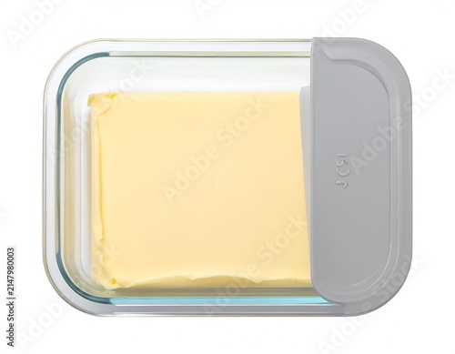 Glass butter dish with a rectangular stick of butter, gray lid on right