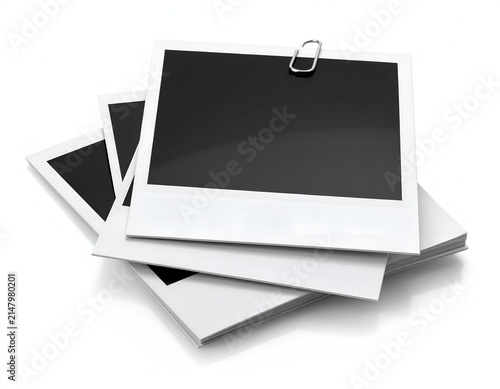 Stack of blank instant photos with a metal clip, on white background, studio shot