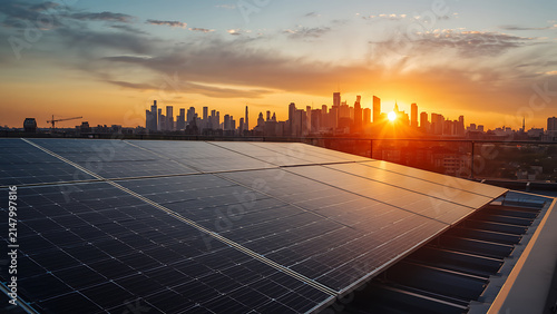 Urban solar panels on rooftop at sunset with cityscape skyline, renewable energy concept