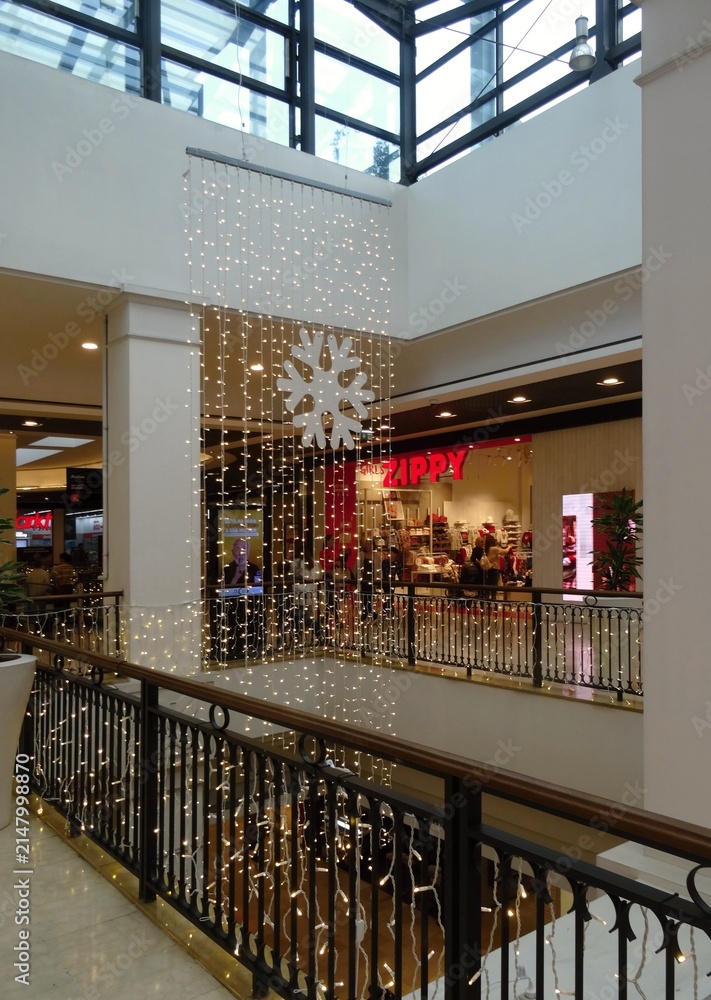 Fototapeta premium Shopping mall interior with Christmas lights and snowflake decoration