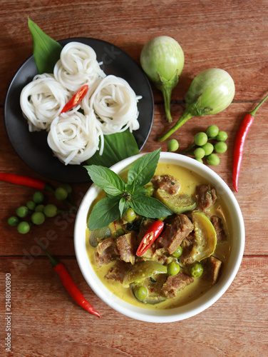Beef green curry with eggplant, chili and basil serve with rice noodle. Authentic Thai food.