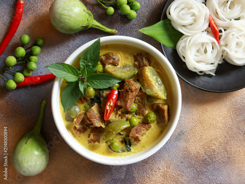 Beef green curry with eggplant, chili and basil serve with rice noodle. Authentic Thai food.