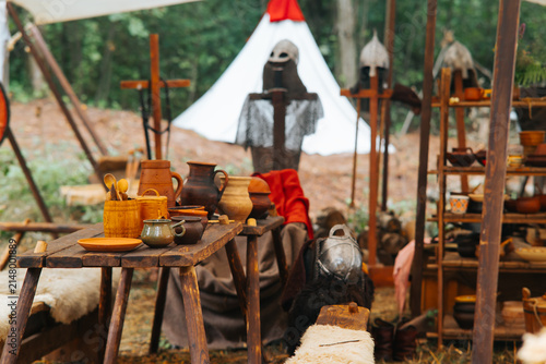 Принти на полотні A medieval reenactment scene shows wooden tables covered with pottery and tools