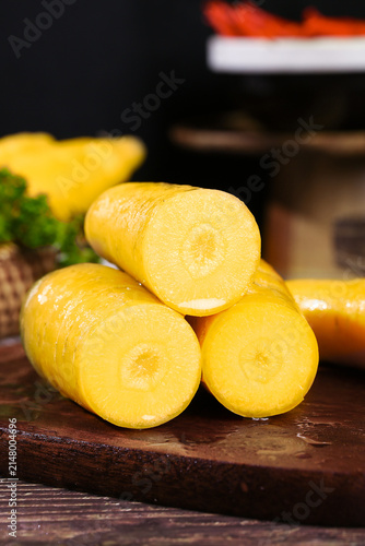 Fresh Yellow Xinjiang Carrots on Wooden Cutting Board - Seasonal Farm Vegetables